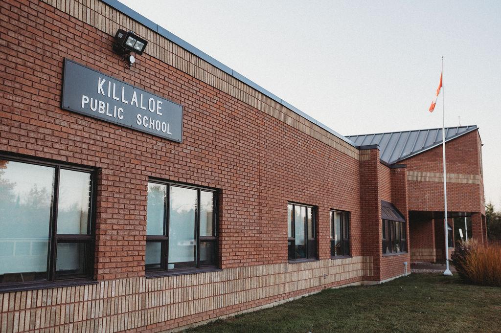 a red bricked building and a Killaloe Public School sign